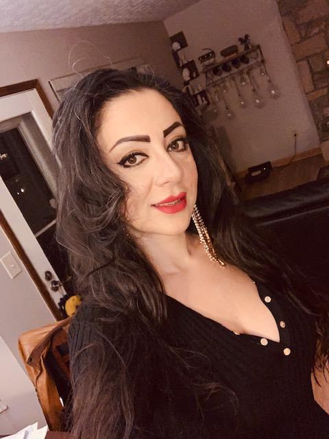 Photo is a headshot of Sona Kazemi: a Middle Eastern woman with long black hair and dark brown eyes. Sona is smiling and wearing a black dress. 